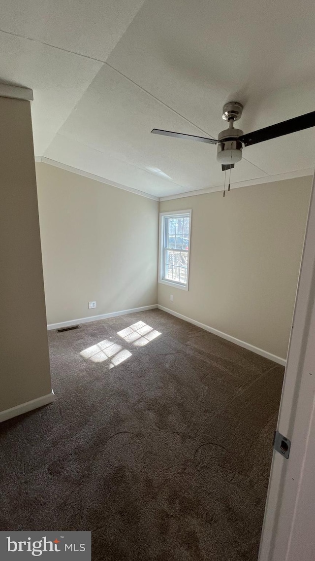 carpeted empty room with a ceiling fan, visible vents, and baseboards