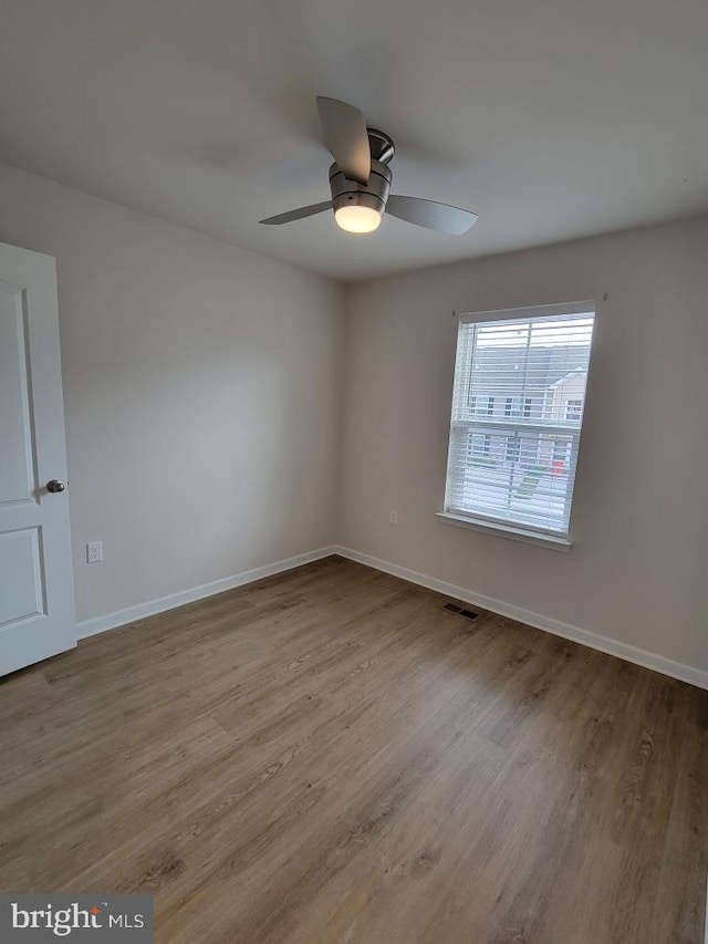 spare room with light hardwood / wood-style floors and ceiling fan