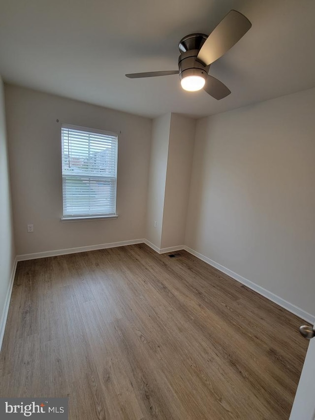 empty room featuring ceiling fan and light hardwood / wood-style floors