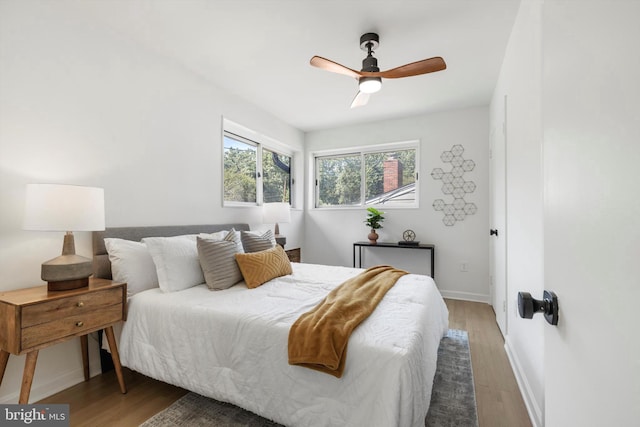 bedroom featuring hardwood / wood-style floors and ceiling fan