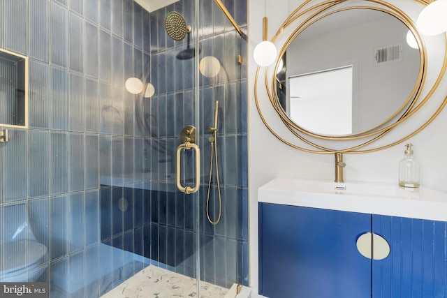 bathroom with vanity and a shower with shower door