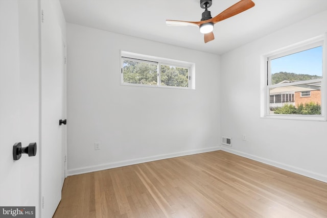 empty room with light wood-type flooring and ceiling fan