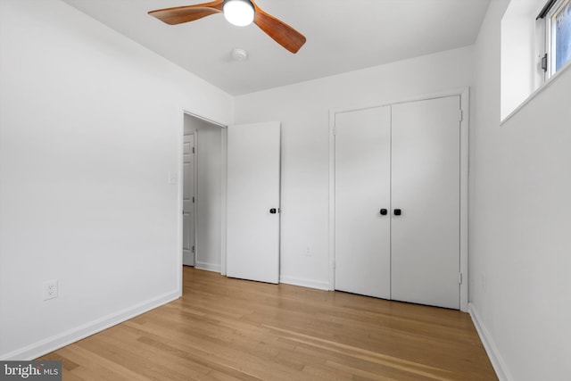 unfurnished bedroom with ceiling fan, light hardwood / wood-style floors, and a closet