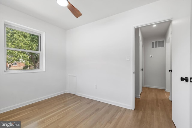 empty room with ceiling fan and light wood-type flooring