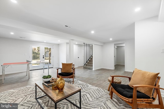 living area featuring light wood-type flooring and french doors