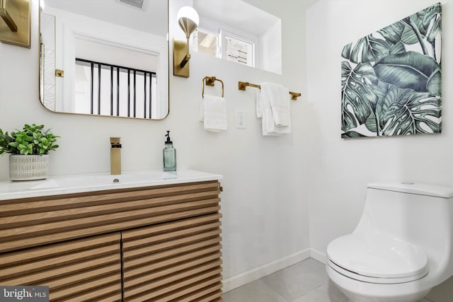 bathroom with tile patterned flooring, vanity, and toilet