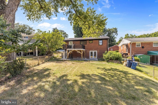 back of property with french doors and a yard