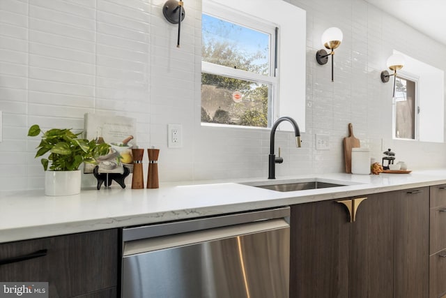 bar with dishwasher, decorative backsplash, dark brown cabinets, and sink