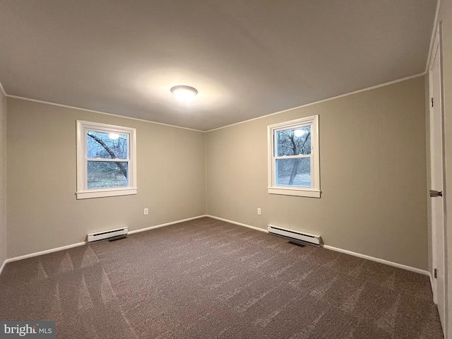 carpeted spare room featuring a baseboard heating unit