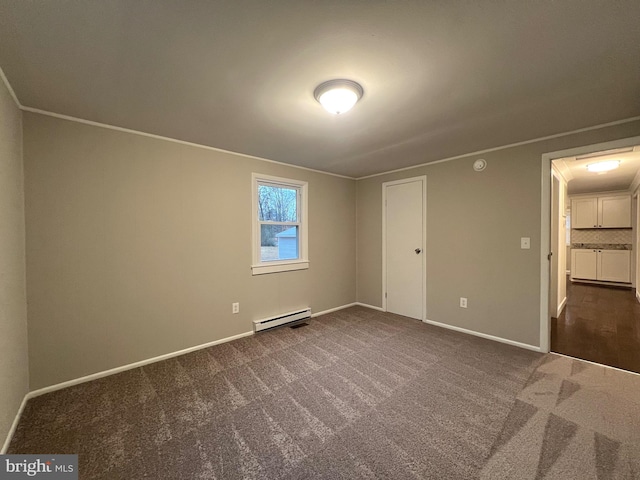 unfurnished bedroom featuring dark colored carpet, a closet, and a baseboard heating unit