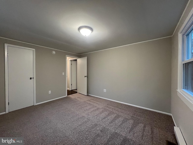 unfurnished bedroom featuring carpet flooring and a baseboard radiator