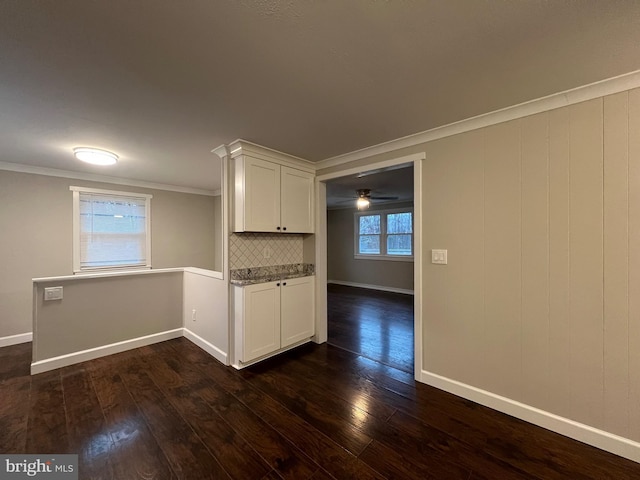 unfurnished room featuring dark hardwood / wood-style flooring and ornamental molding