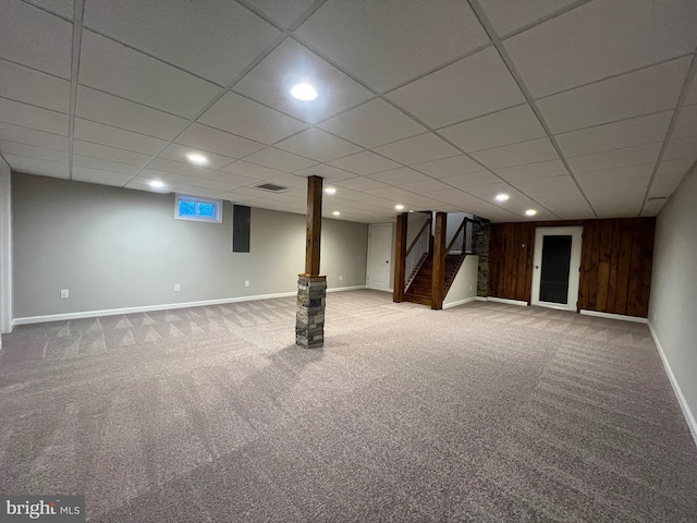 basement with wooden walls and carpet floors