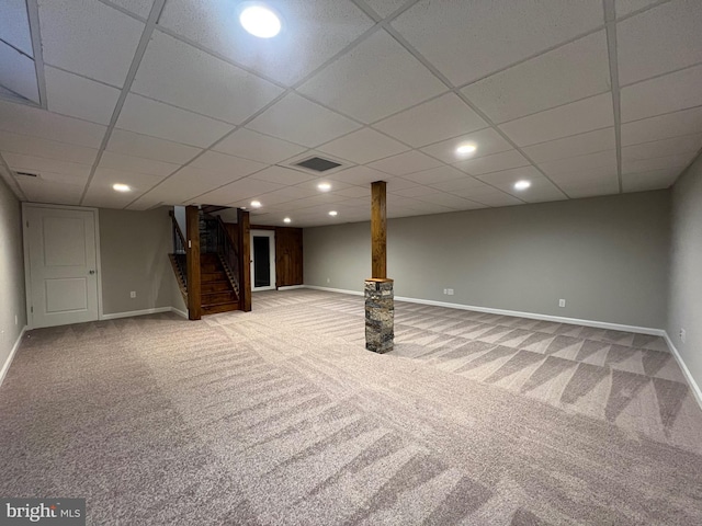 basement featuring carpet flooring and a drop ceiling