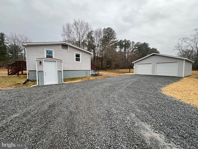 view of home's exterior featuring a garage and an outbuilding