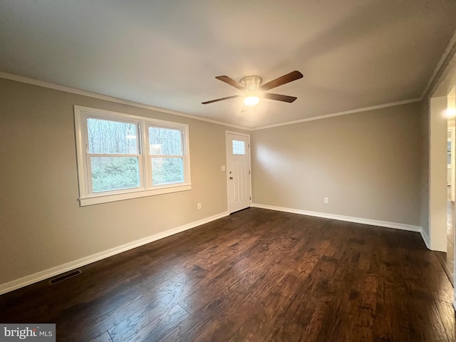 spare room with dark hardwood / wood-style floors, ceiling fan, and crown molding