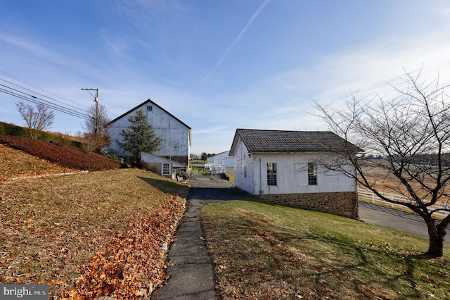 view of side of property with a lawn