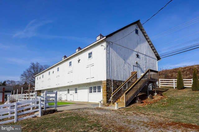 back of property with a lawn and a patio