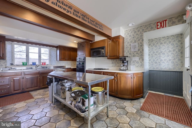 kitchen featuring a center island, black appliances, and sink