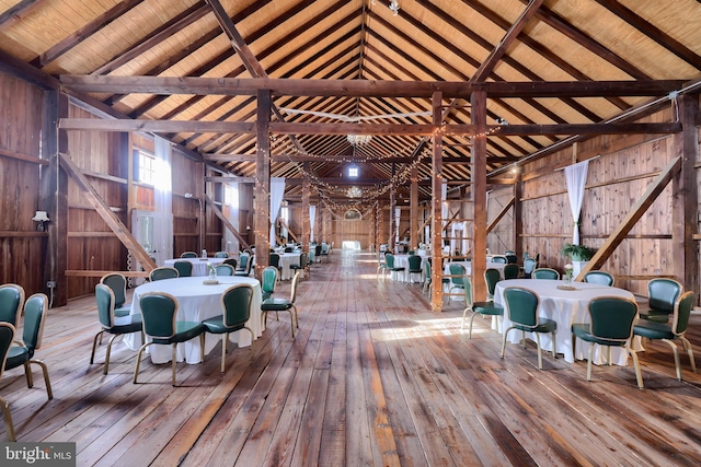 interior space featuring high vaulted ceiling, beam ceiling, wood ceiling, and wooden walls