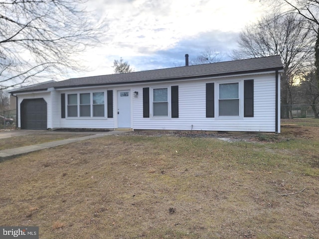 single story home with a garage and a front lawn