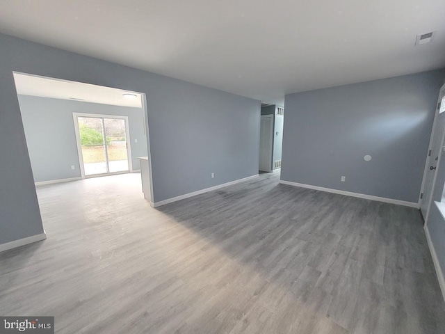 unfurnished room with hardwood / wood-style flooring