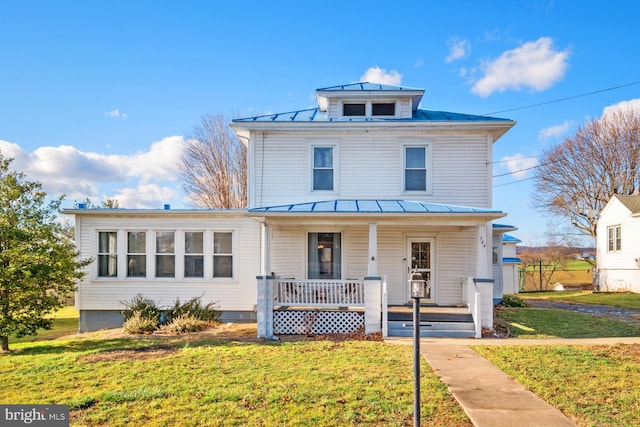 view of front of home with a porch and a front yard