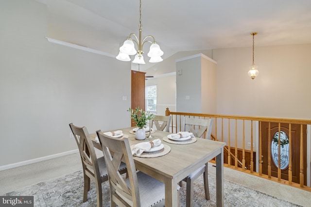 carpeted dining room featuring a chandelier and lofted ceiling