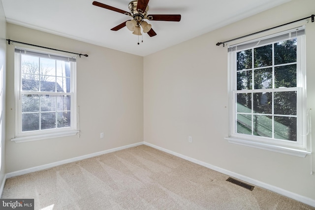 carpeted empty room with ceiling fan