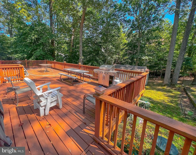 wooden deck with a grill