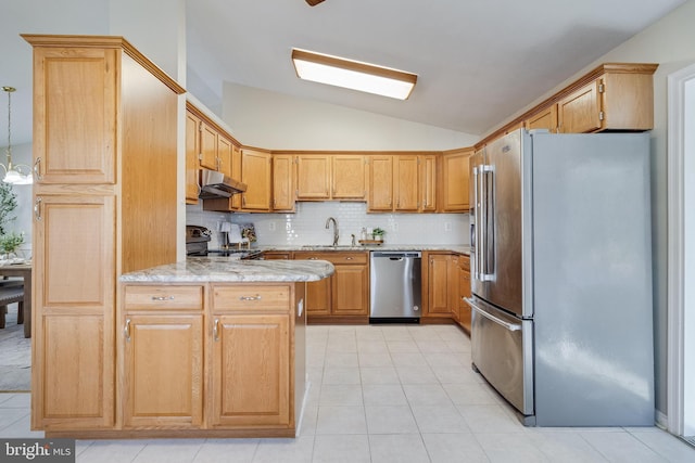 kitchen with sink, tasteful backsplash, light stone counters, vaulted ceiling, and appliances with stainless steel finishes