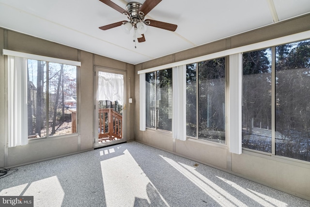 unfurnished sunroom featuring ceiling fan