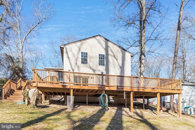 rear view of property featuring a wooden deck