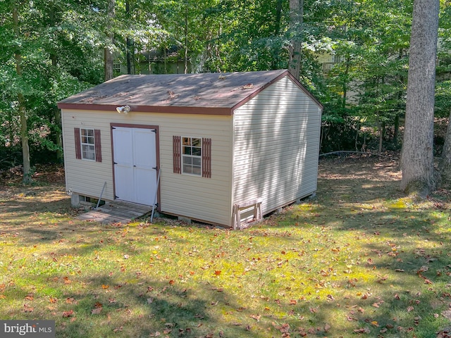 view of outbuilding with a lawn