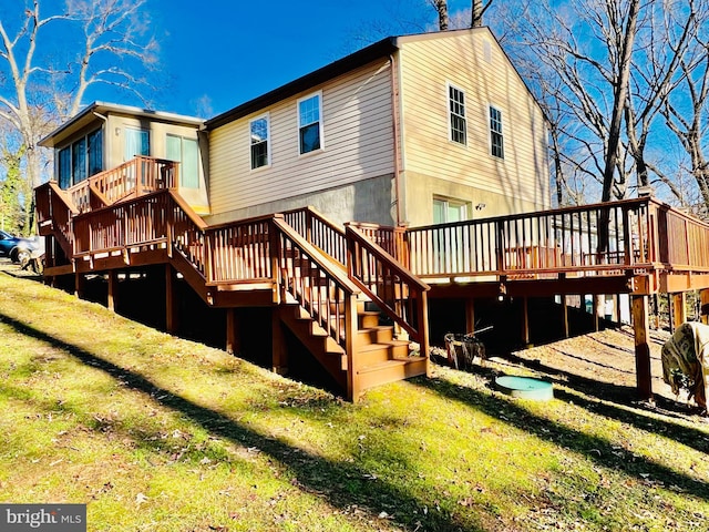 back of house with a lawn and a wooden deck