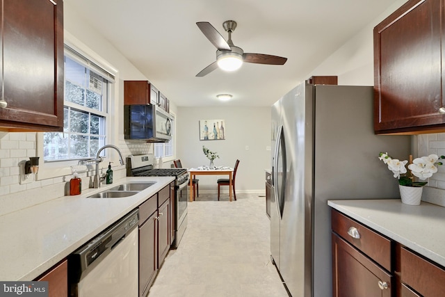 kitchen with decorative backsplash, sink, ceiling fan, and stainless steel appliances