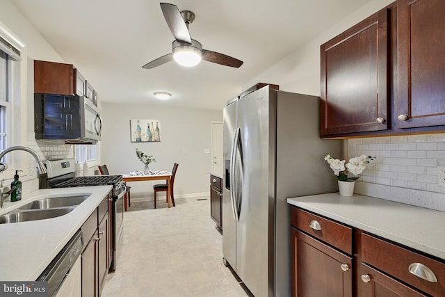 kitchen with decorative backsplash, sink, ceiling fan, and appliances with stainless steel finishes