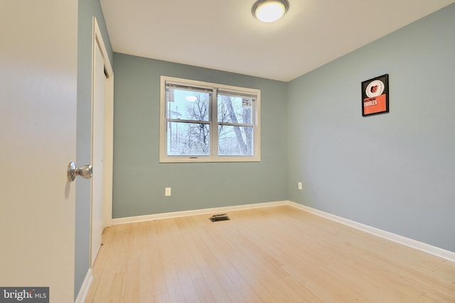 unfurnished room featuring light hardwood / wood-style floors