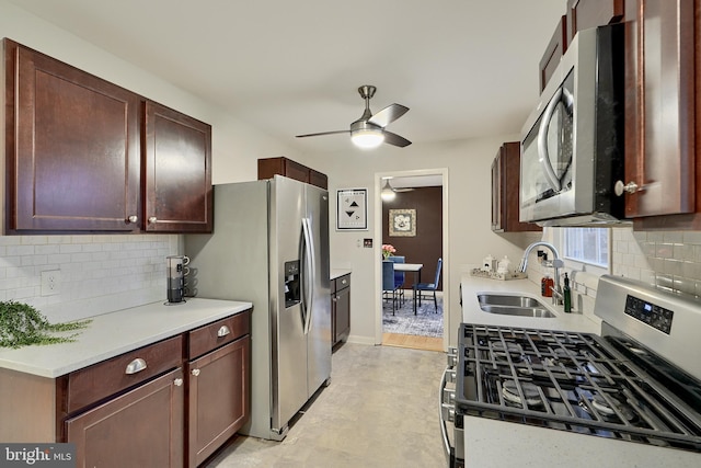 kitchen featuring decorative backsplash, ceiling fan, sink, and appliances with stainless steel finishes