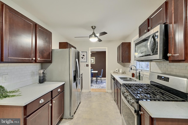 kitchen featuring decorative backsplash, ceiling fan, sink, and stainless steel appliances