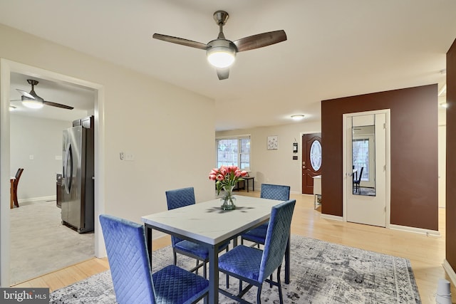 dining room with light hardwood / wood-style floors and ceiling fan