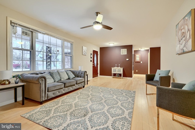 living room with wood-type flooring and ceiling fan