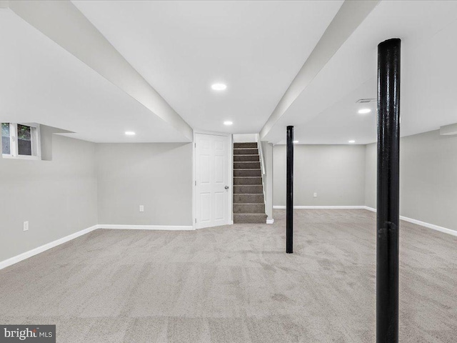 basement featuring light colored carpet