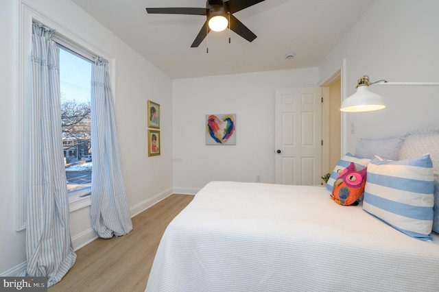 bedroom with light hardwood / wood-style floors and ceiling fan