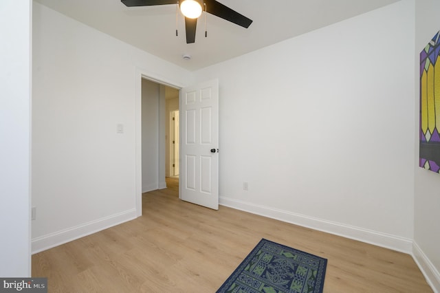 empty room with light hardwood / wood-style flooring and ceiling fan