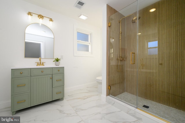 bathroom featuring vanity, toilet, and an enclosed shower