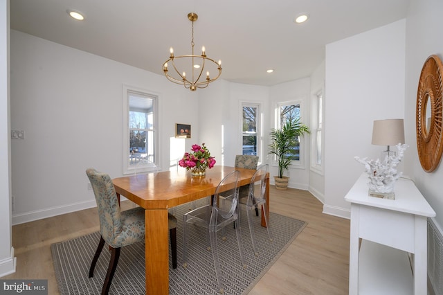 dining room featuring a chandelier and light wood-type flooring