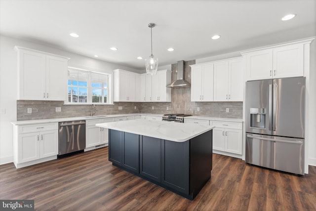 kitchen featuring white cabinetry, wall chimney exhaust hood, and stainless steel appliances