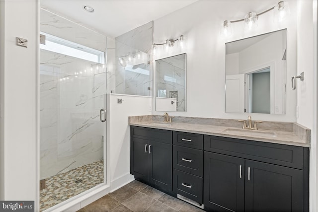 bathroom featuring vanity and a shower with shower door