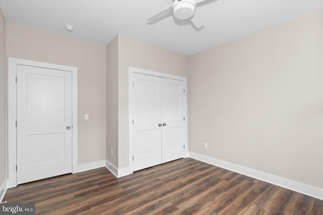 unfurnished bedroom featuring dark hardwood / wood-style floors and ceiling fan